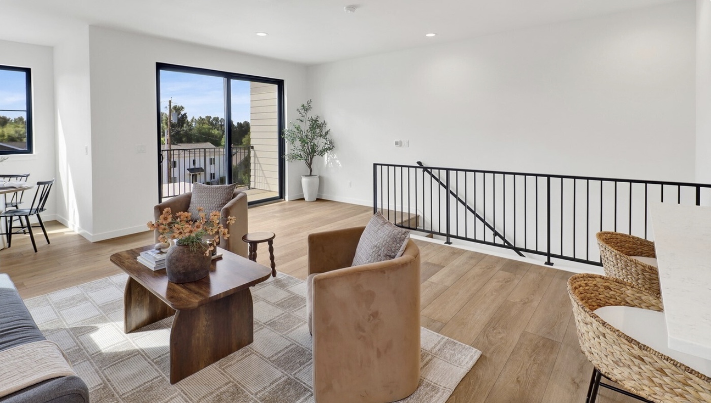 Bright Holland Lofts living room with balcony and mountain views