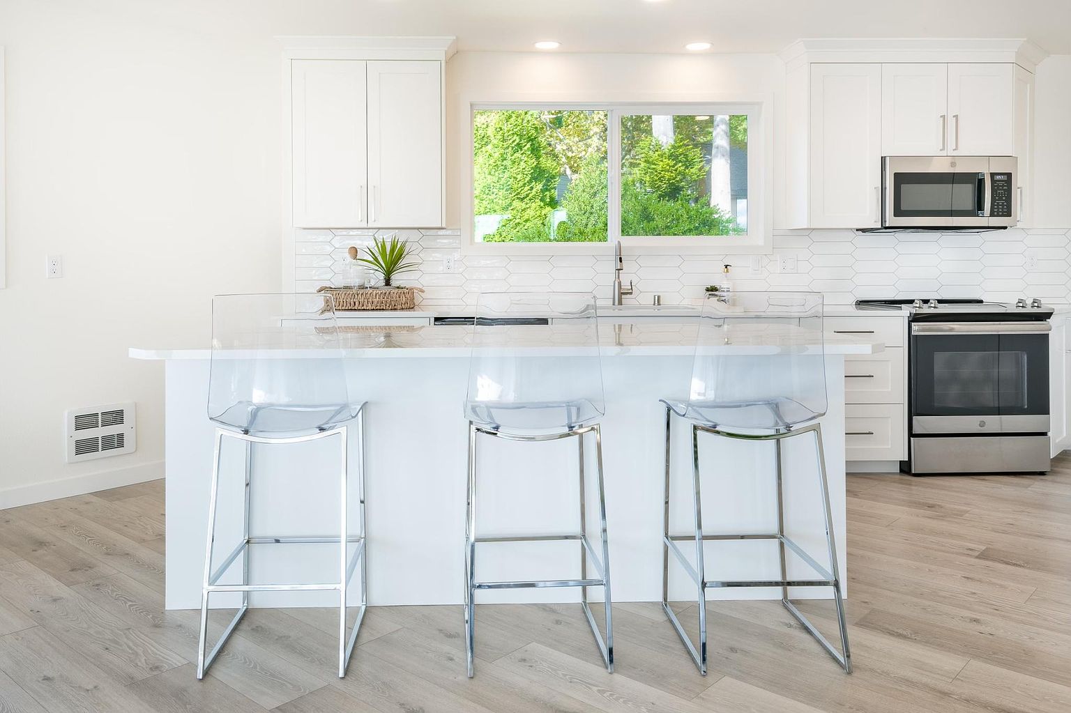 Remodeled white kitchen with large island
